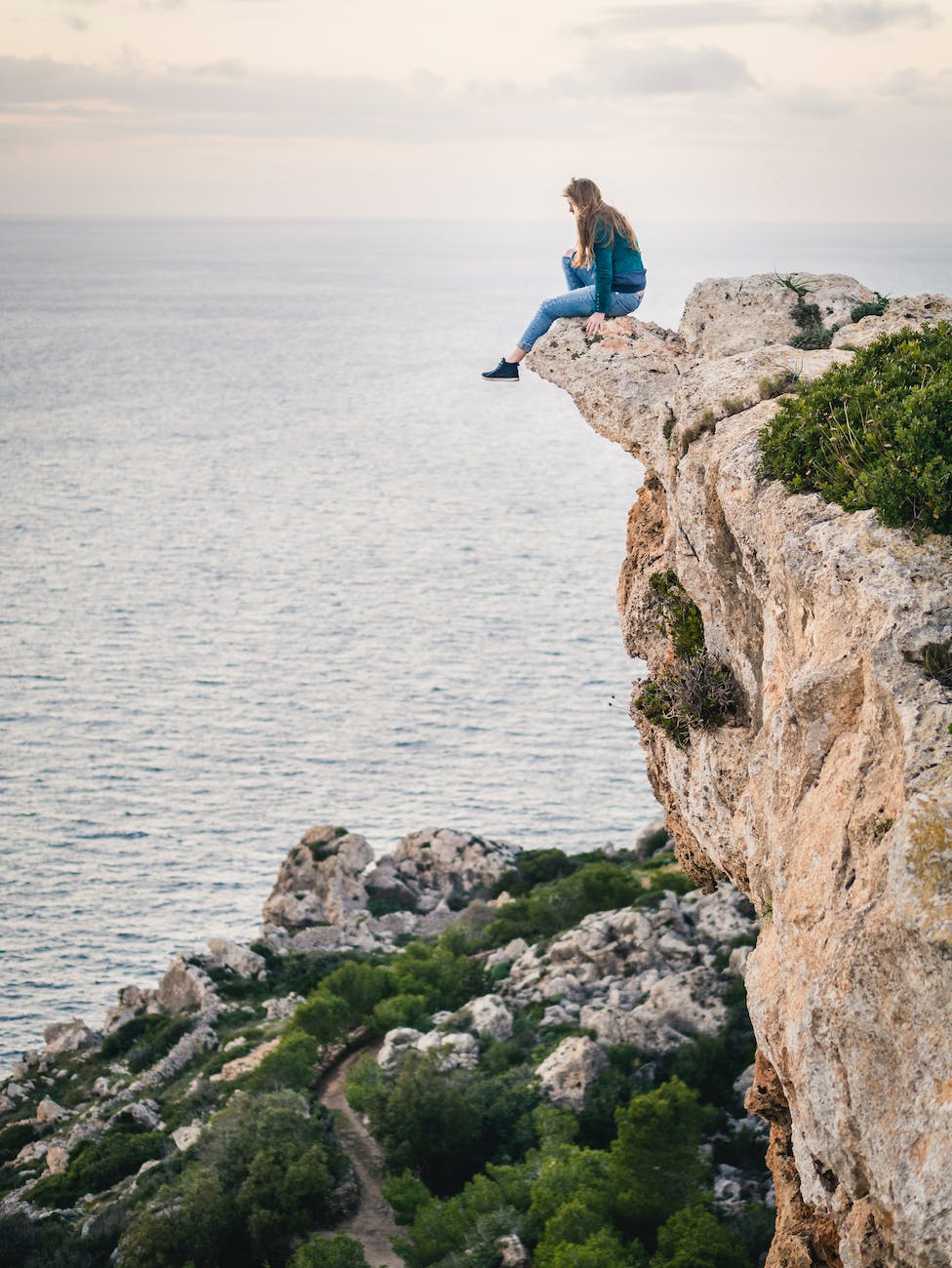 woman sitting on mountain